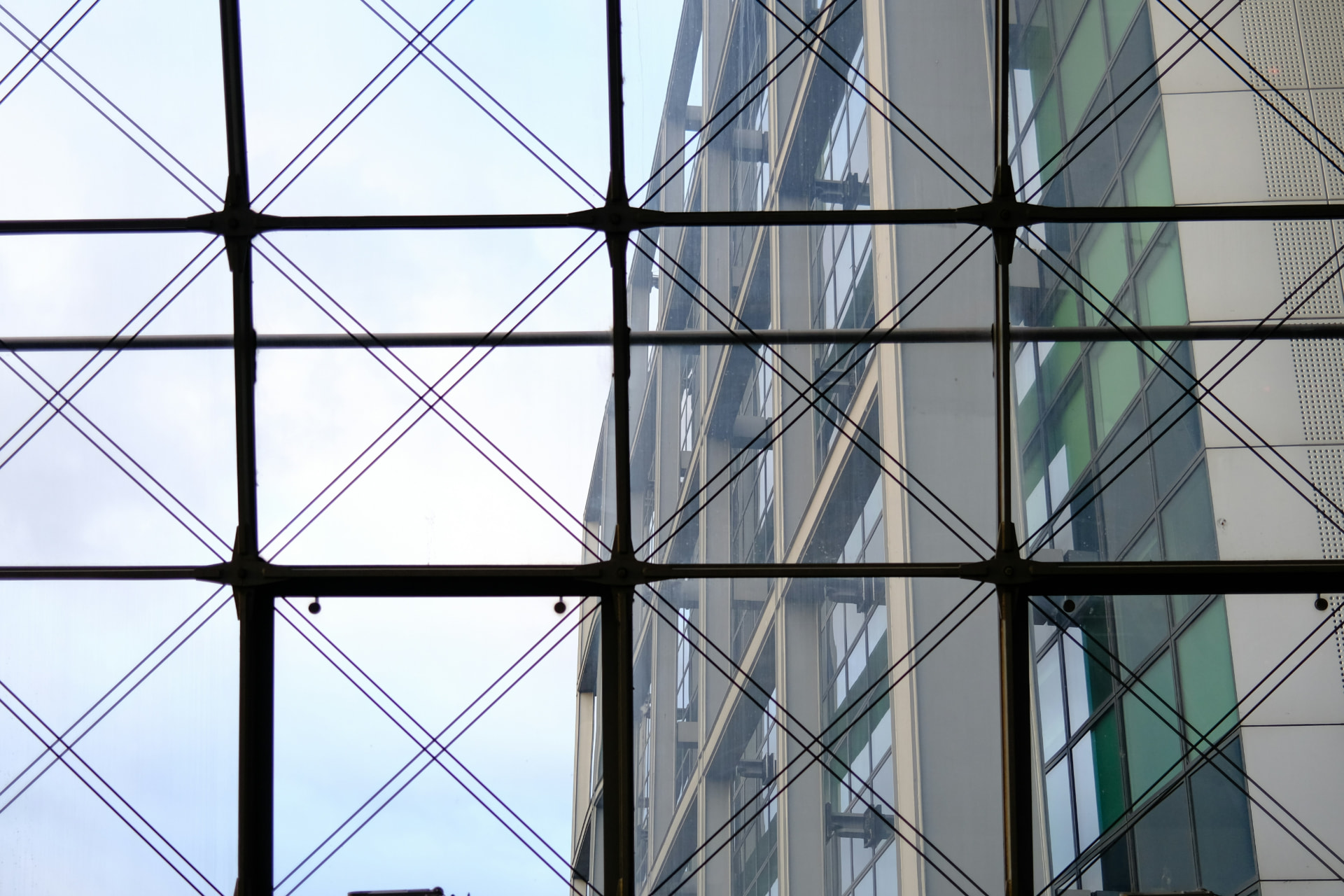Modern building facade viewed through structural glass framework